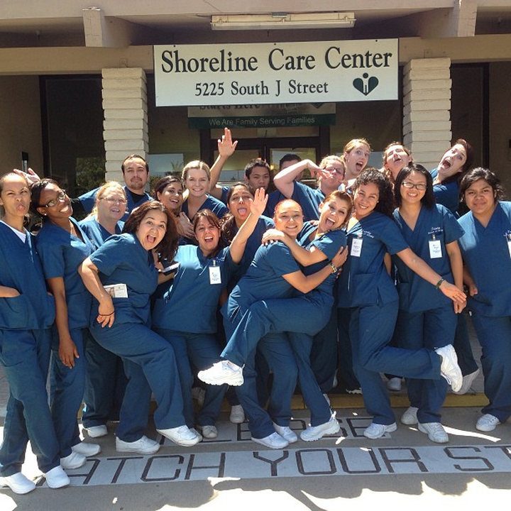 A group outside Victoria Care Center