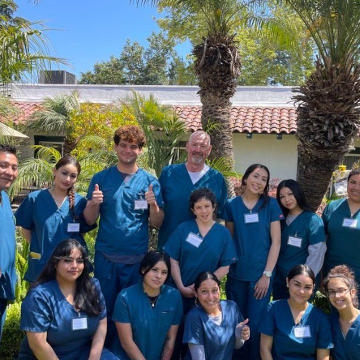 A Trinity group in scrubs posing indoors